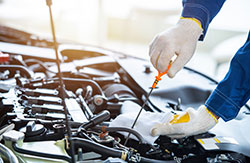 Automotive technician works on the brakes of a car