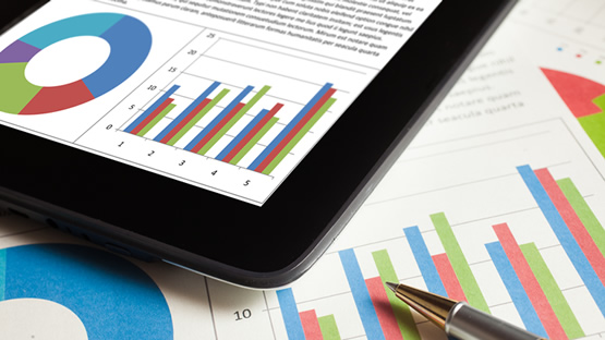 Spreadsheet data with a pen and tablet placed on top of the information