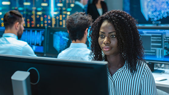 Woman sitting in front of computer monitor