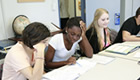 Three students prepare for a social science project