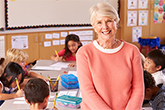 Teacher with students working on their assignments