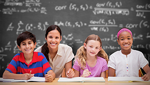 Teacher posing with three students