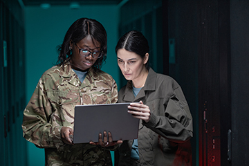 A mentor assisting a veteran in a server room