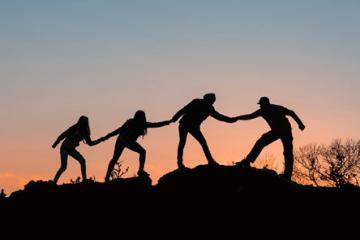 Silhouette of people holding hands