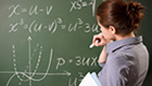 An instructor drawing mathematical equations on a chalkboard