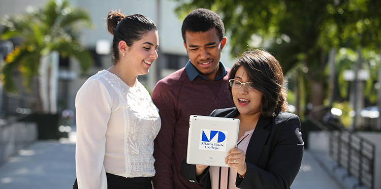 Students looking at a mobile device