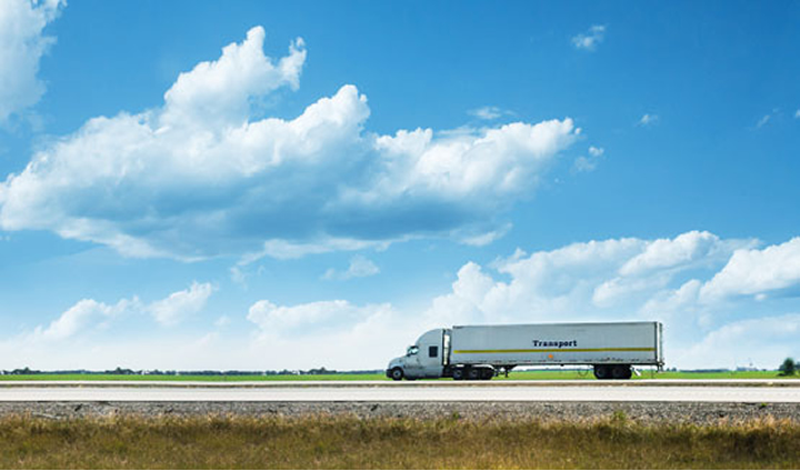 truck driving on a long highway